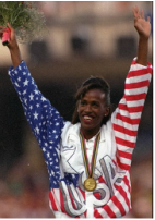 Jackie Joyner-Kersee wearing red-white-blue jacket with arms raised after getting Olympic medal